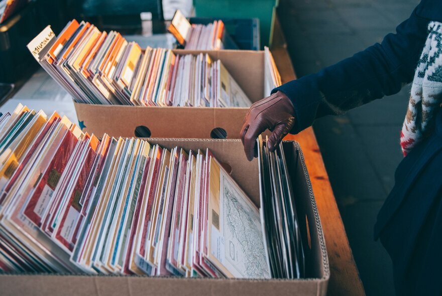Someone flipping through a box of records.