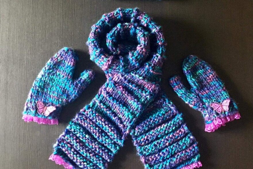 Blue hand knitted scarf and matching mittens.