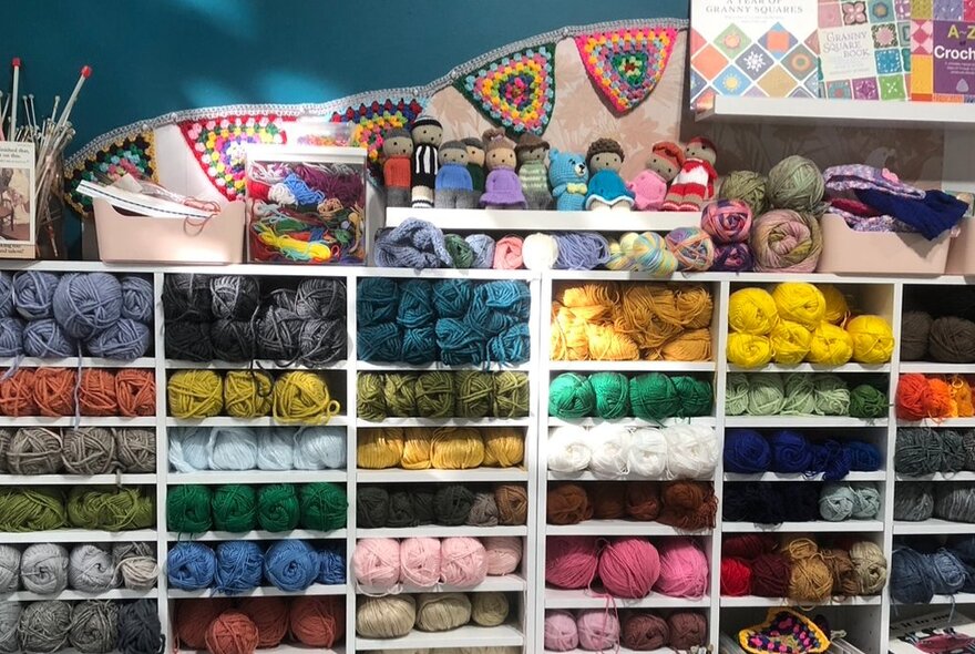 Wool shop displays of coloured skeins of wool.