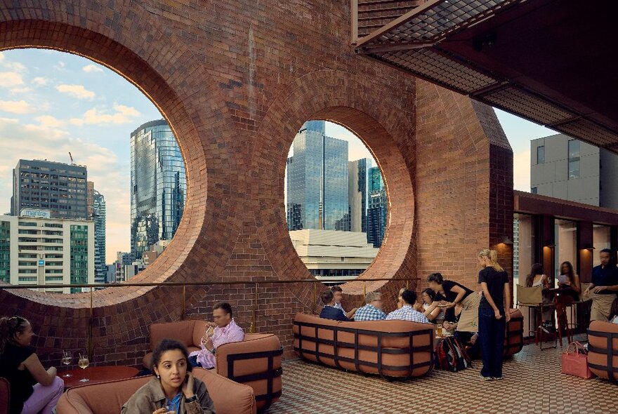 A rooftop bar with large circular windows.