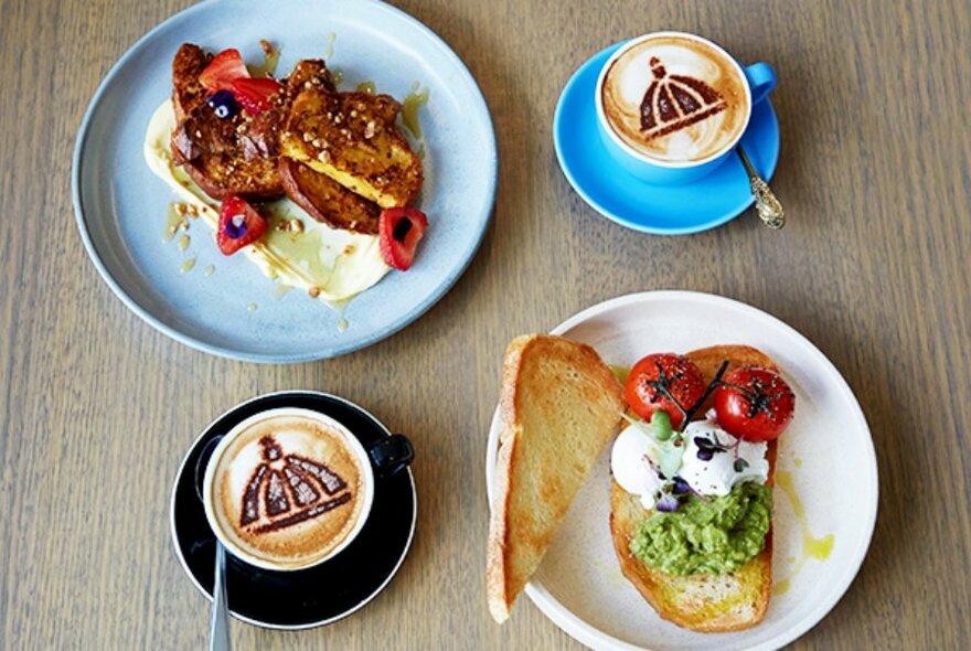 Overhead view of two plates of food and two cups of coffee.