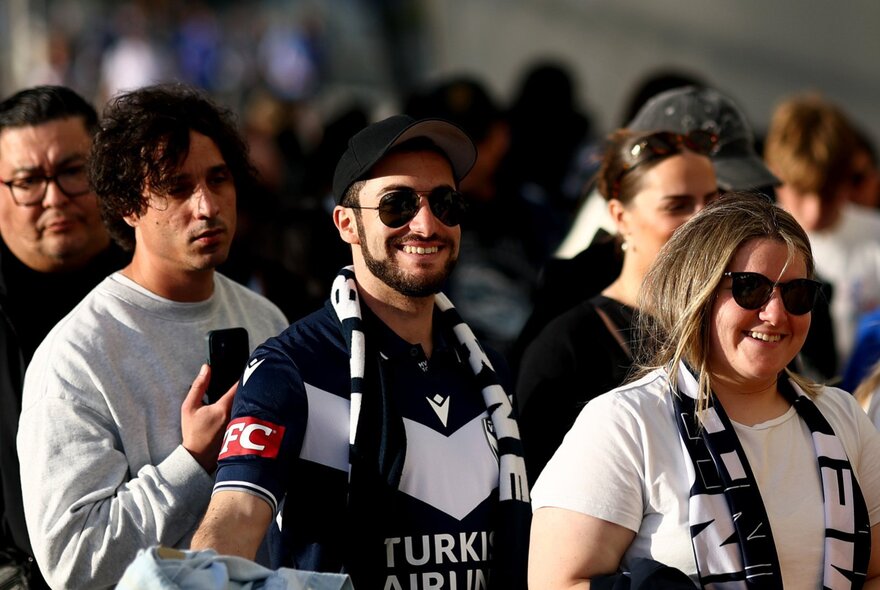 Melbourne Victory A-League players in Victory merchandise.