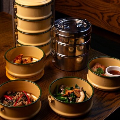 A traditional Thai meal served in a stacked container, each layer separated out.