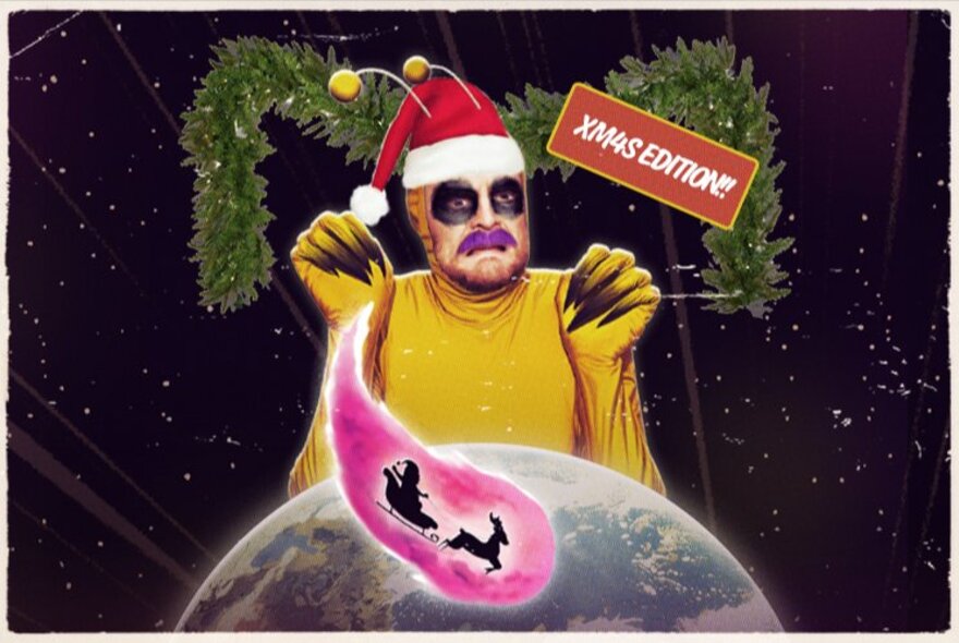 A person dressed as an alien wearing a yellow bodysuit and a Santa hat with yellow antennae, in front of an image of Earth and a pink speech bubble with Santa and his reindeer inside it.