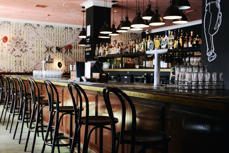 Long bar with stools laid out along it.