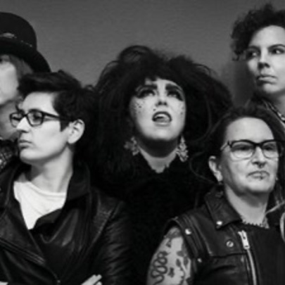 Five women dressed like a rock band.