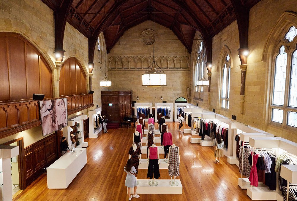 A clothing store inside a large chapel.