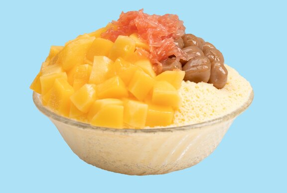 A mango bingsu, with fresh chopped mango and taro ball topping over shaved ice.
