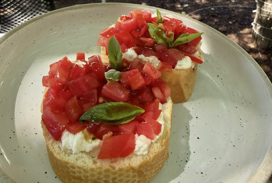 Close-up of bruschetta, served on a white plate.