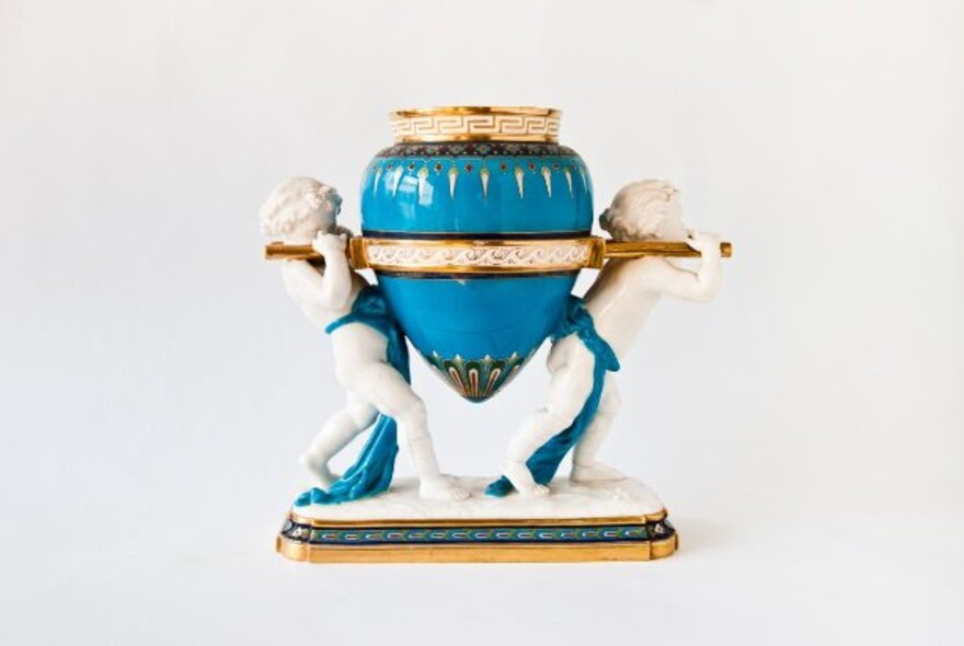 Mid-Victorian Minton porcelain vase, with two cupids carrying a turquoise urn.