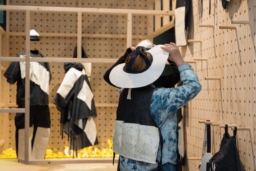 A person interacting with a display in the EMERGENCE[Y] exhibition at Science Gallery.