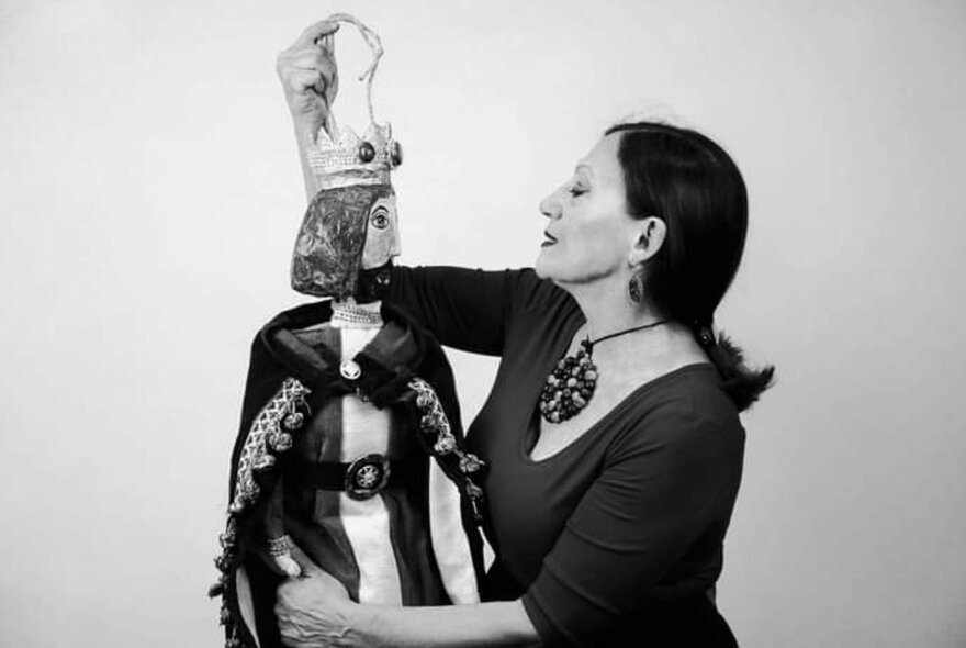 Black and white photograph of Italian singer, Sara Cappella, holding a traditional Italian puppet.