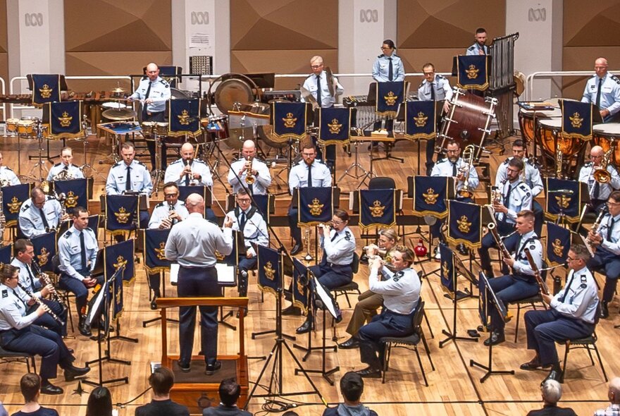 The Air Force Band playing inside a music auditorium.