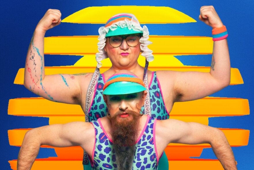 Two drag performers posing in strong-man stances while dressed in blue and pink leopard print leotards and visors. 