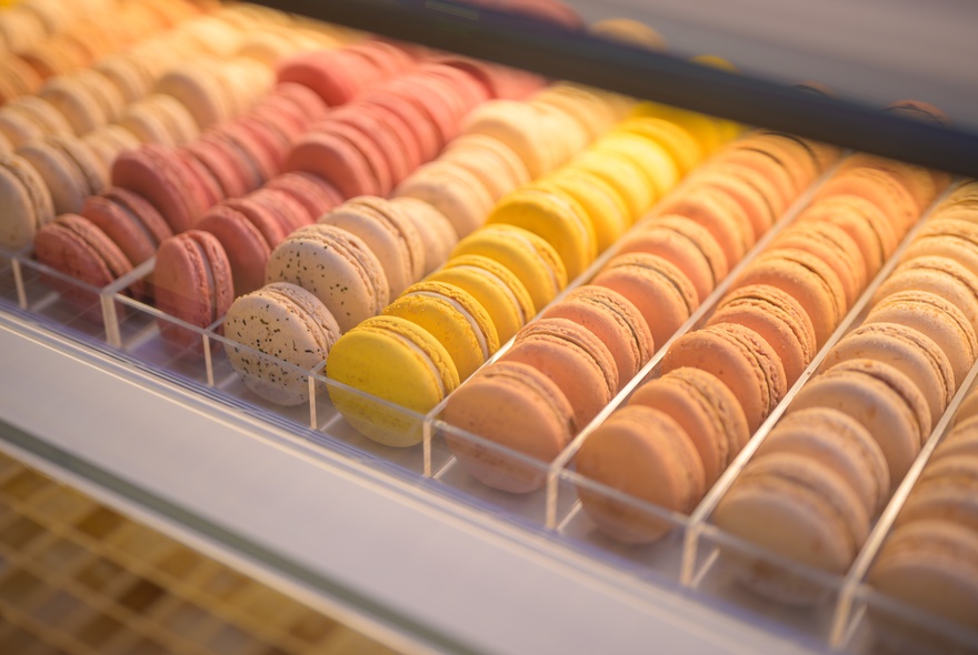 Rows of pastel-coloured macarons on display.
