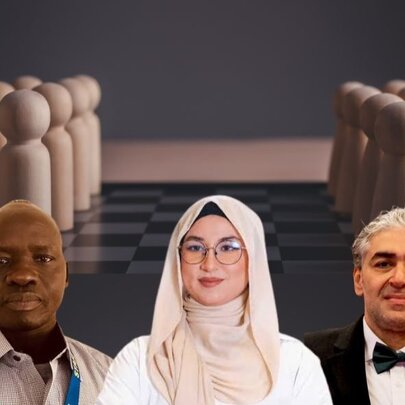 Three people with wooden pegs on a chessboard behind them. 