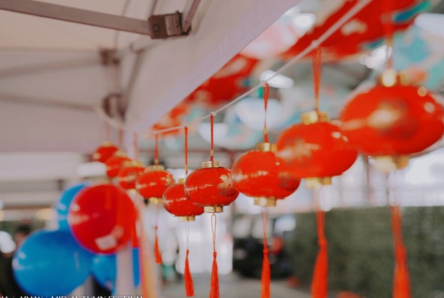 Red Chinese lanterns hanging in a row at the Moon Festival at Queen Victoria Market.