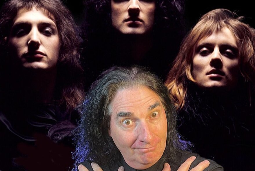 A man standing in front of a picture of Queen from the Bohemian Rhapsody film clip. 