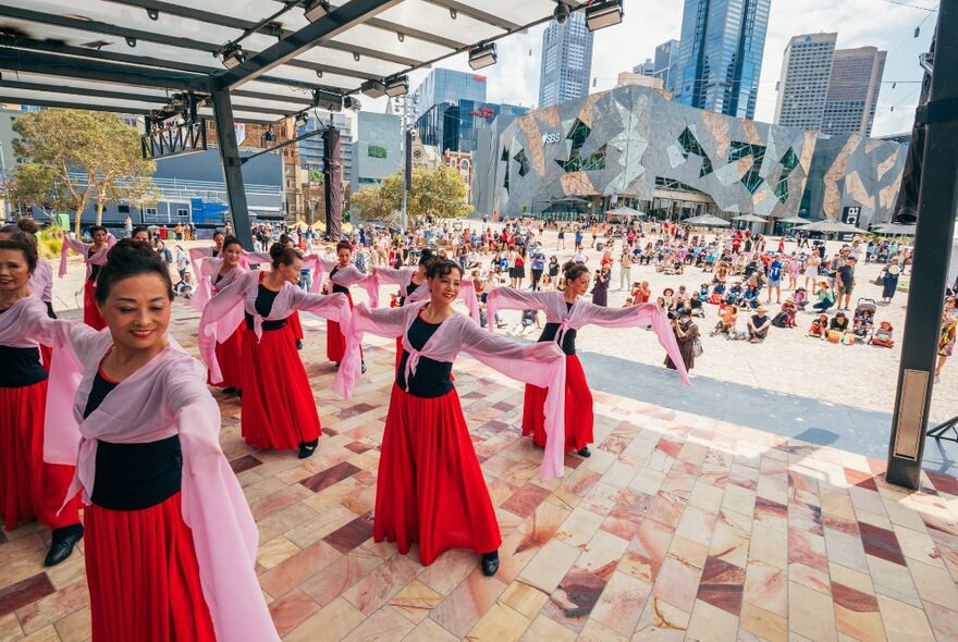 Traditional Chinese dancers performing under a pavilion at Fed Square.