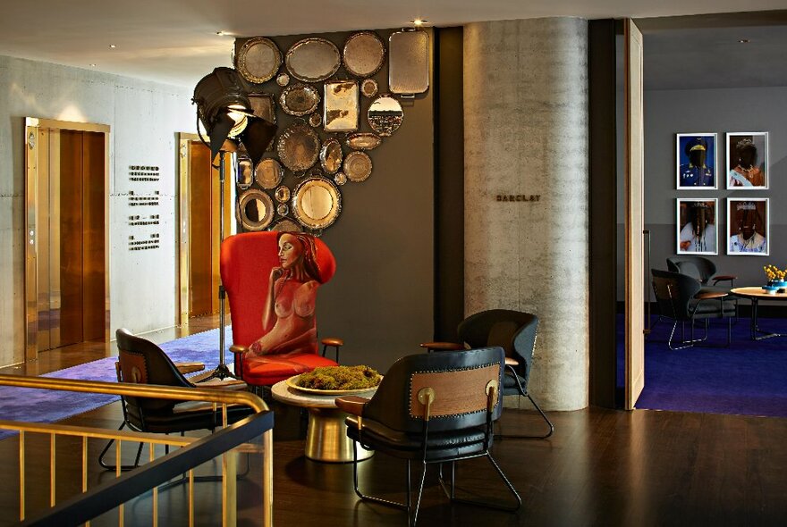 Hotel meeting space with retro seating, mirrors and framed prints.