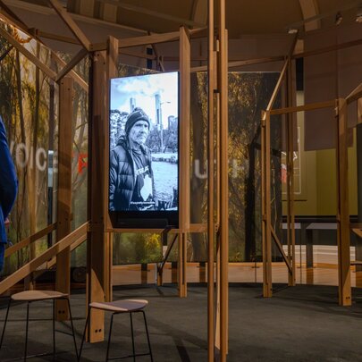 A person looking at an exhibition at the State Library Victoria, specifically designed to display the original 1835 treaty documents. 
