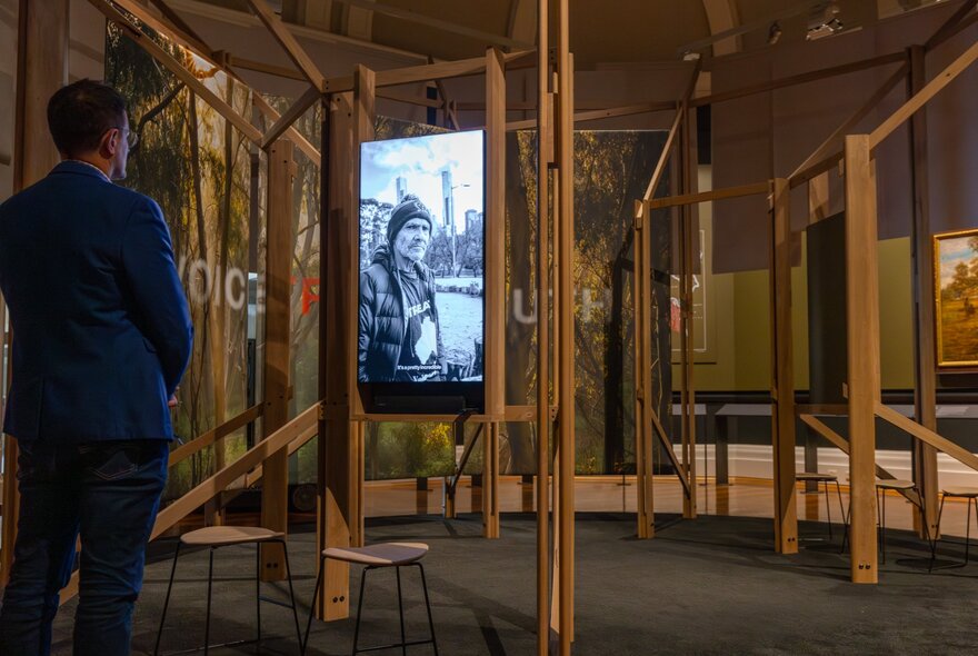 A person looking at an exhibition at the State Library Victoria, specifically designed to display the original 1835 treaty documents. 
