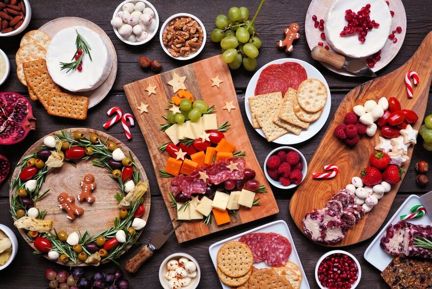 Festive breakfast buffet platters with fruit displayed in the shape of a Christmas tree, cheese, charcuterie and fruit.