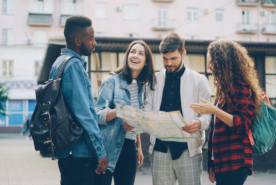People holding a map in front of a tram.