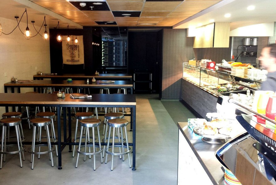 Interior of Humbaba: benches and stools on the left, counter to the right.