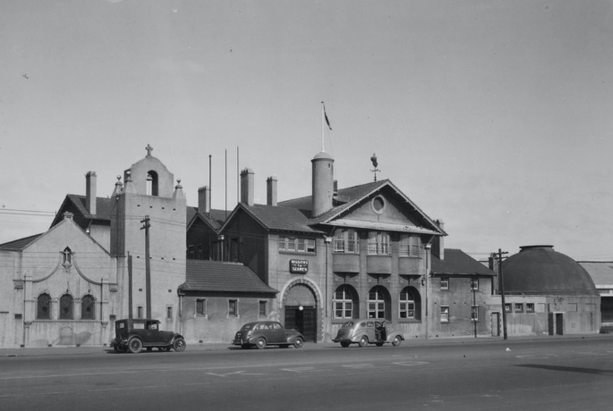 Vintage photograph of the Mission to Seafarers building exterior, with cars dating from the 1930 parked in front.