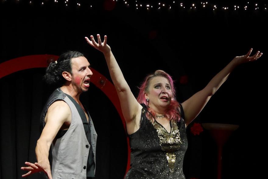 Impro performers on a stage acting out a scene.