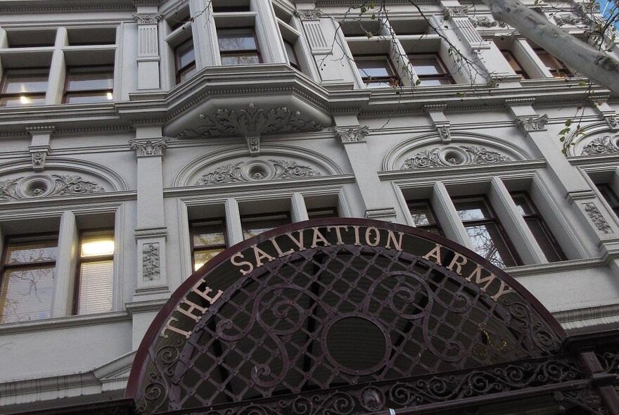 View from the street looking up at the historic Victorian-era Salvation Army building facade.