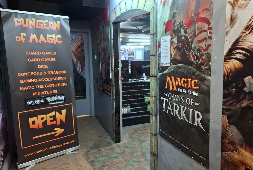 Dungeon of Magic store doorway with posters and signage.