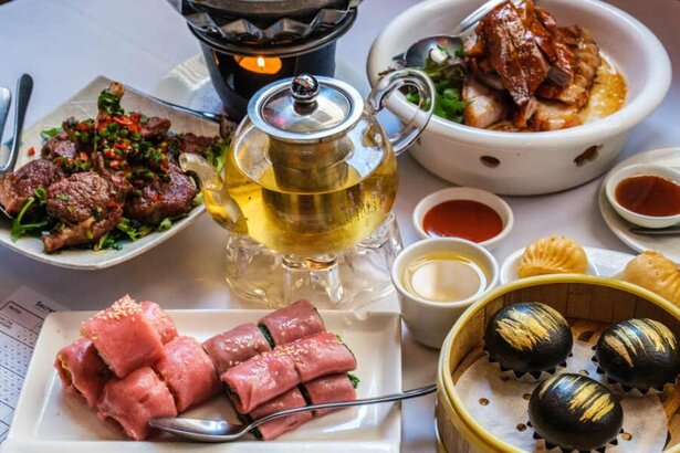 Dumplings, BBQ meats and sauce plates on a table