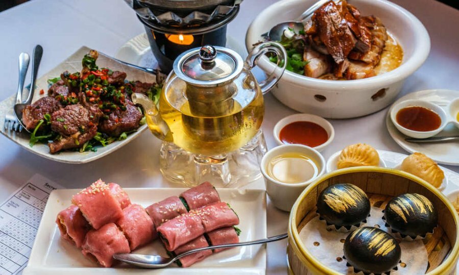 Dumplings, BBQ meats and sauce plates on a table