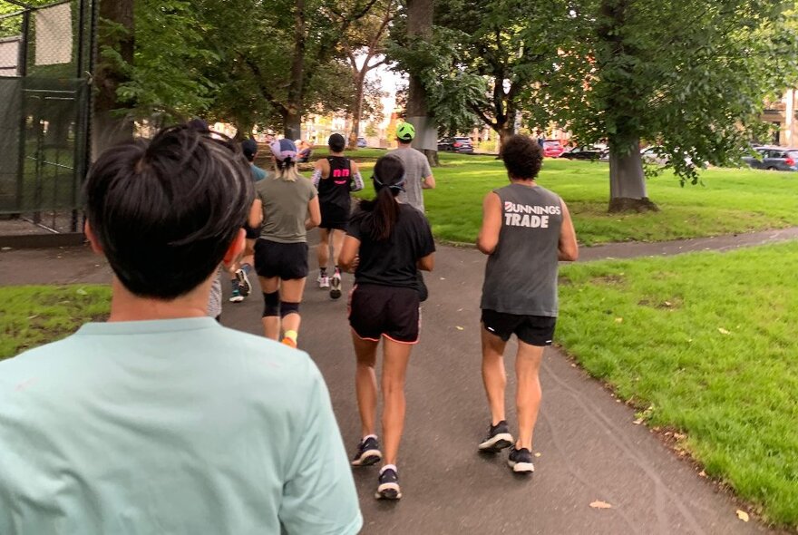 People running on the path around Carlton Gardens.