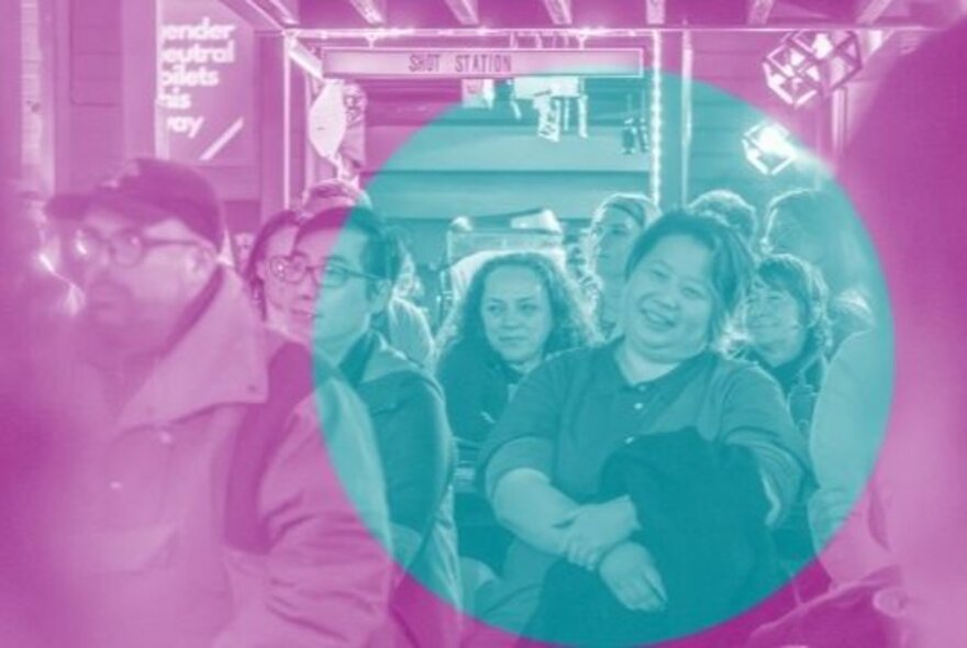 A crowd of people standing, listening and watching an event; the image is stylized with a dual-tone colour filter, a teal circle over a magenta wash.