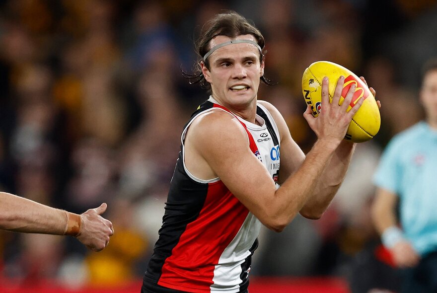 St Kilda AFL football player with the ball during a match.