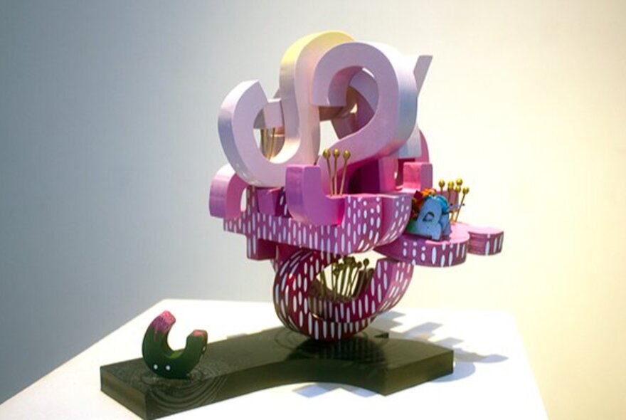 Sculpture made up of coloured letters, all jumbled together.
