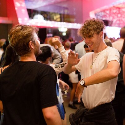 Two young men dancing at a nightclub.
