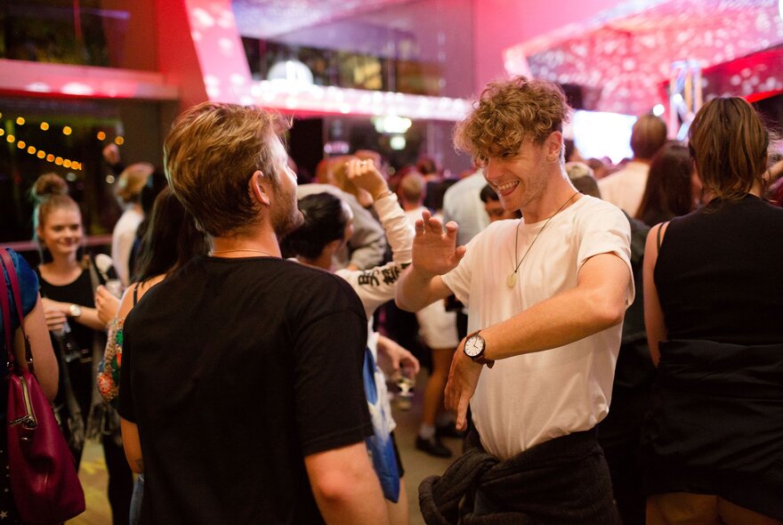 Two young men dancing at a nightclub.