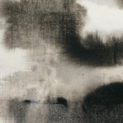 An obscure image with monochrome tones resembling plumes of smoke. 