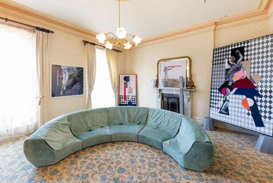 A suite at the Hotel Windsor decorated with several contemporary art works hanging on the walls.