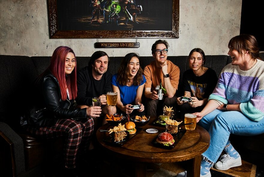 People enjoying drinks and snacks in a lounge environment.