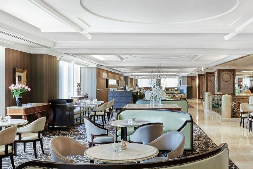 Comfortable chairs in a light-filled hotel bar.