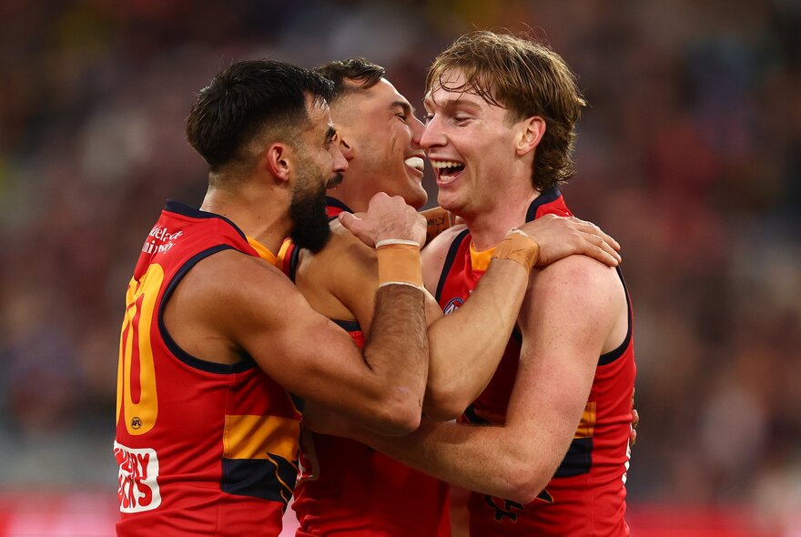 Adelaide AFL football players on the field during a match.
