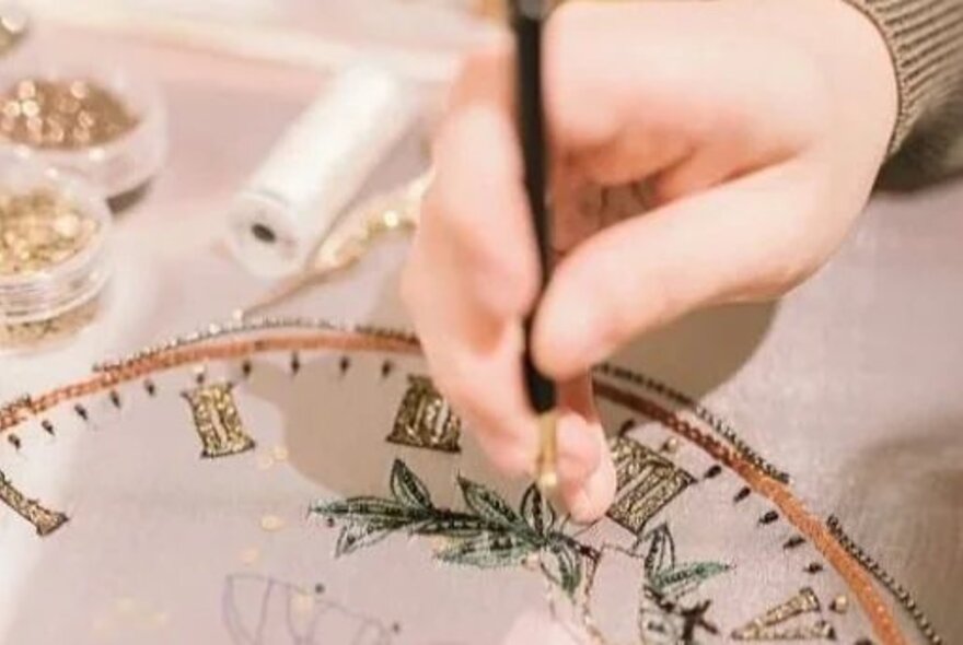 A person engaged in embroidery.