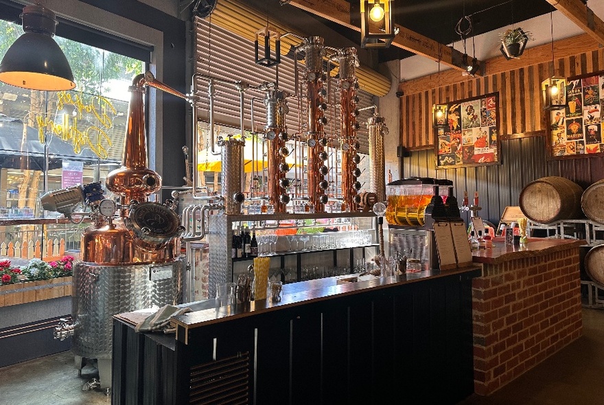 Wine bar shopfront with counter and bottles.