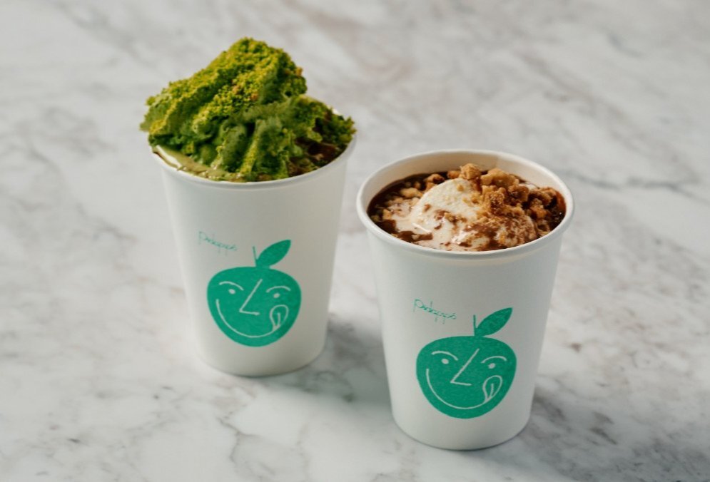 A matcha gelato hot chocolate and a hot chocolate with a scoop of gelato
