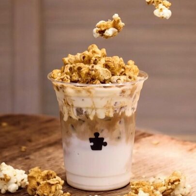 An iced latte with popcorn on top.